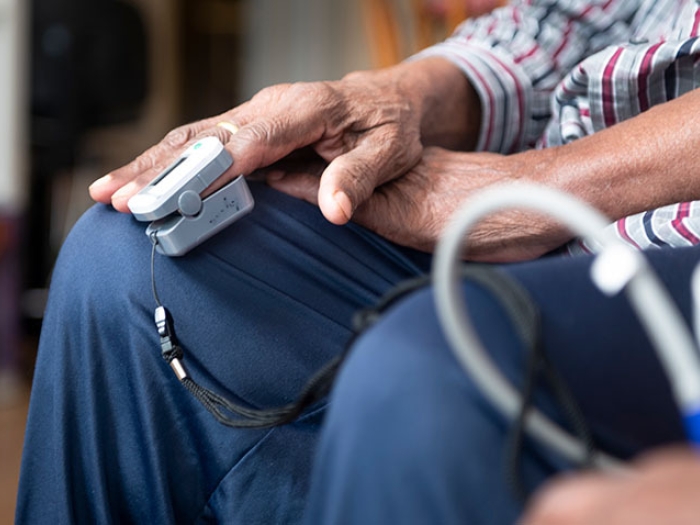 older person getting oxygen reading