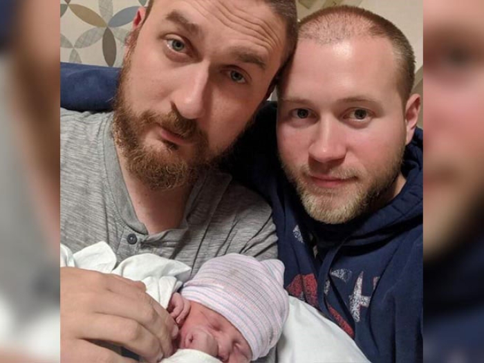 Parents holding new baby
