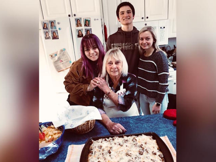 Woman in kitchen with grandchildren