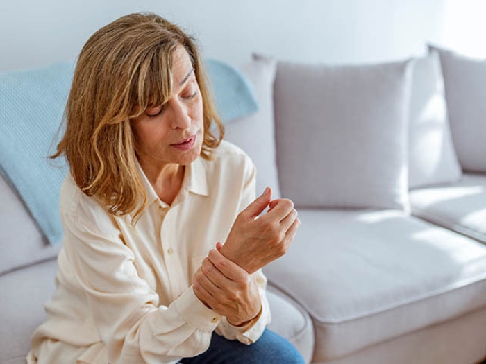 Women on couch with wrist hurting