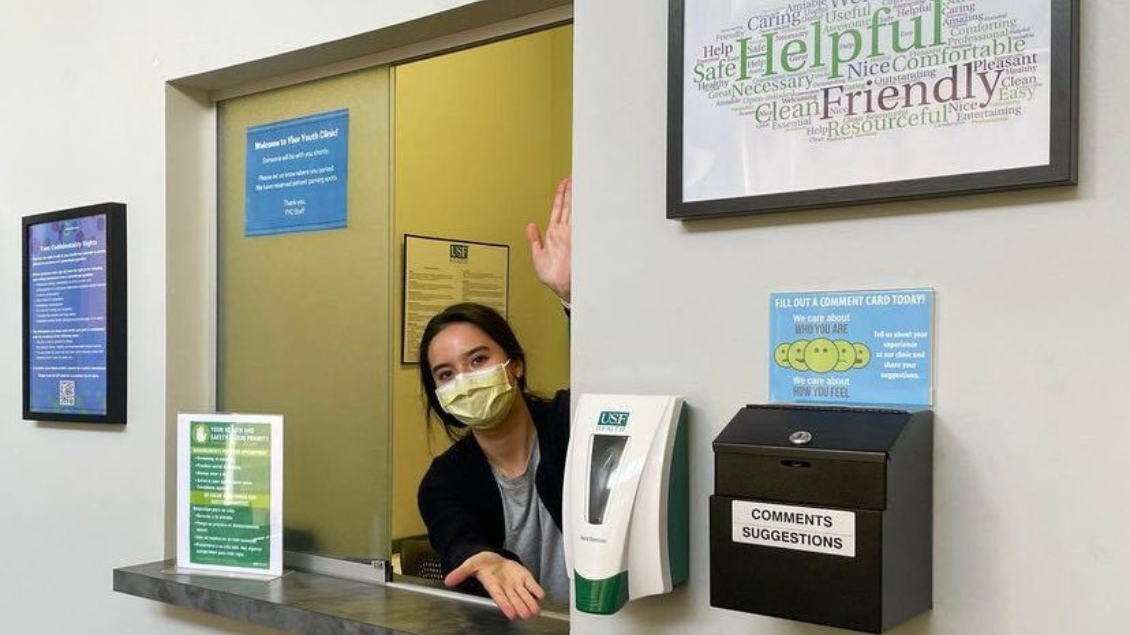 A picture of a health care professional at intake window at a clinic