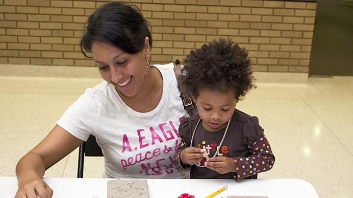 Mother and daughter working together on art project