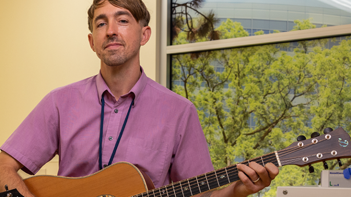 male musician playing guitar